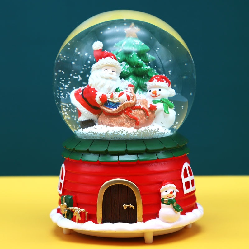 Đỏ - Ô.G.Noel và NT túi quà - Quả cầu tuyết Ông già Noel Merry Christmas có Nhạc và Đèn - 14.2x10.5x10.5cm (Trang trí Giáng Sinh)