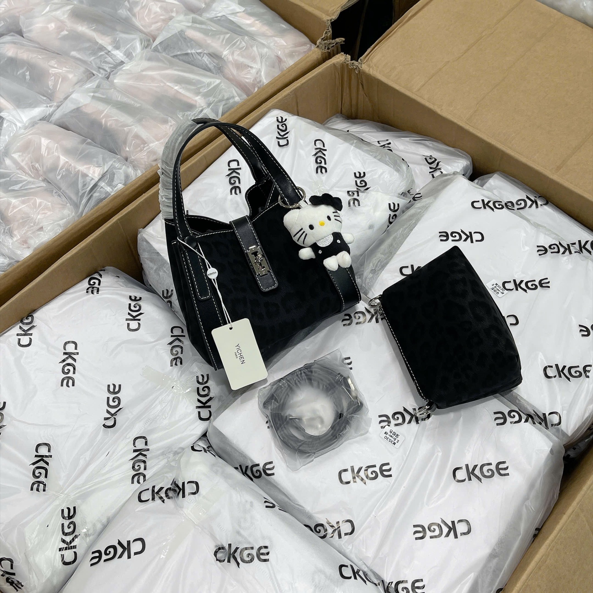 TUI ĐEN VIỀN CHỈ TRẮNG KÈM CHARM MÈO M265182