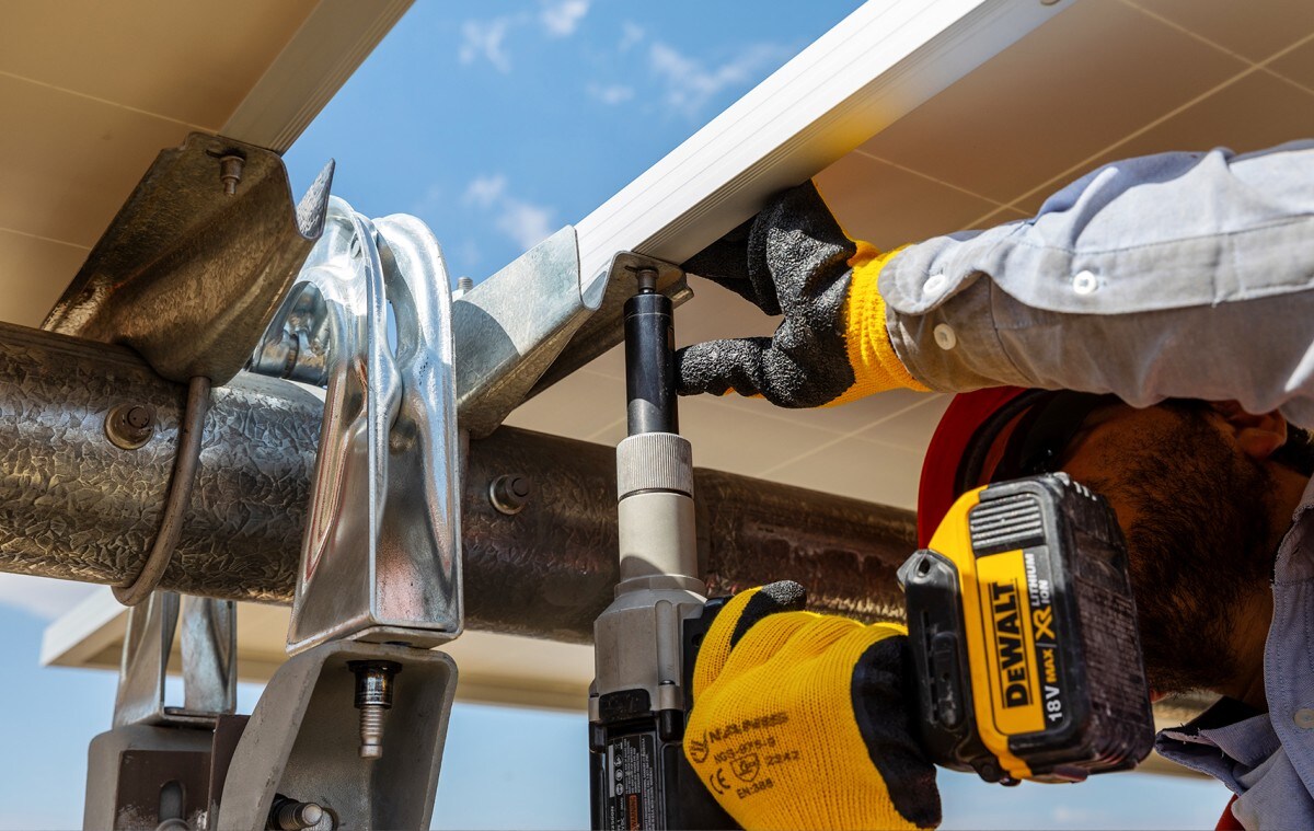 Man installing solar panel using DeWALT tool