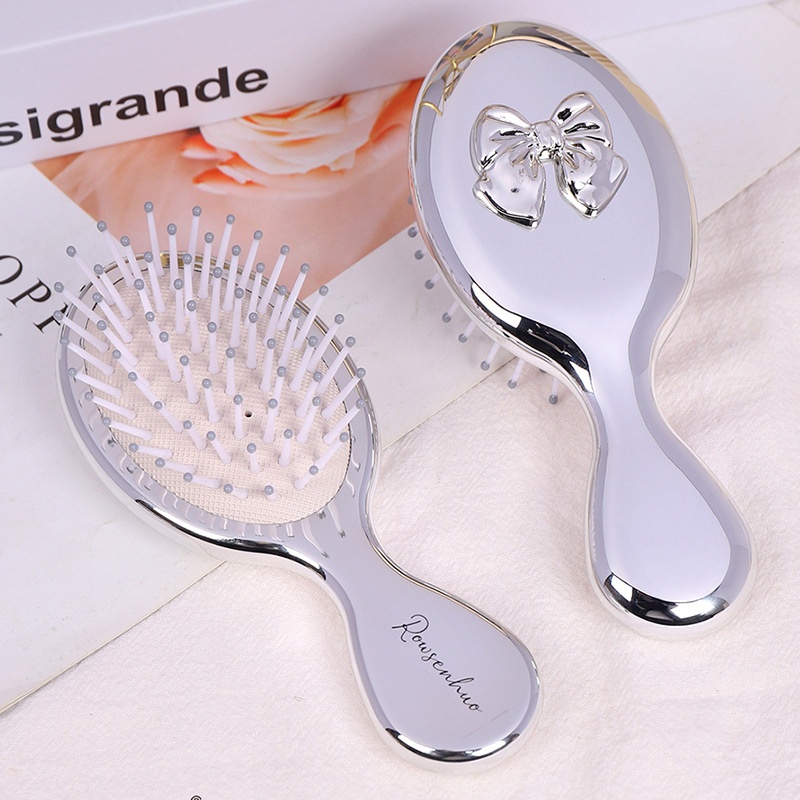 Lược massage bạc đính nơ