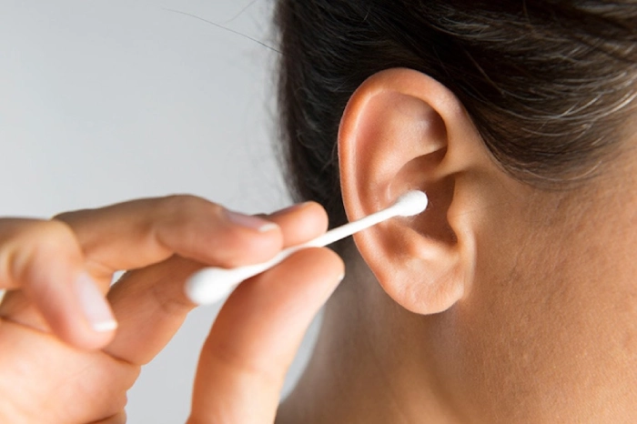 Sử dụng tăm bông để làm sạch nhẹ nhàng khu vực tai ngoài
