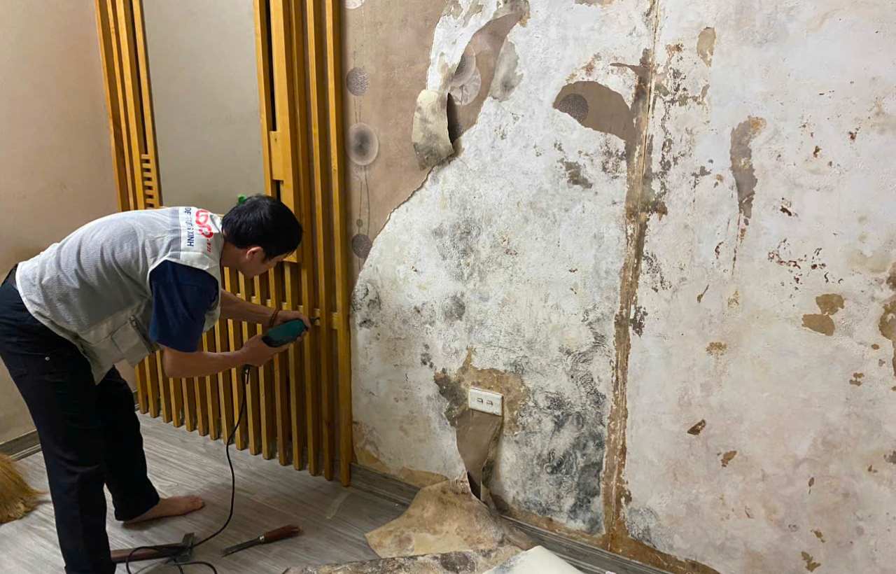 Thợ xử lý tường trước khi thi công ốp tường.jpg