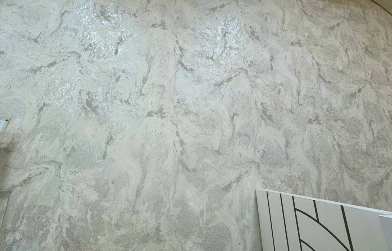 Concrete-effect wallpaper installation for a modern interior in Hanoi