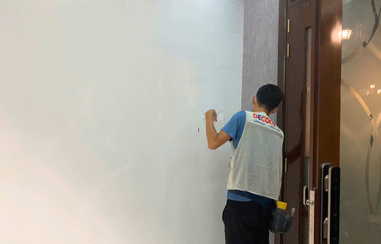 Wallpaper installation worker at apartment in Thu Thiem, Ho Chi Minh City