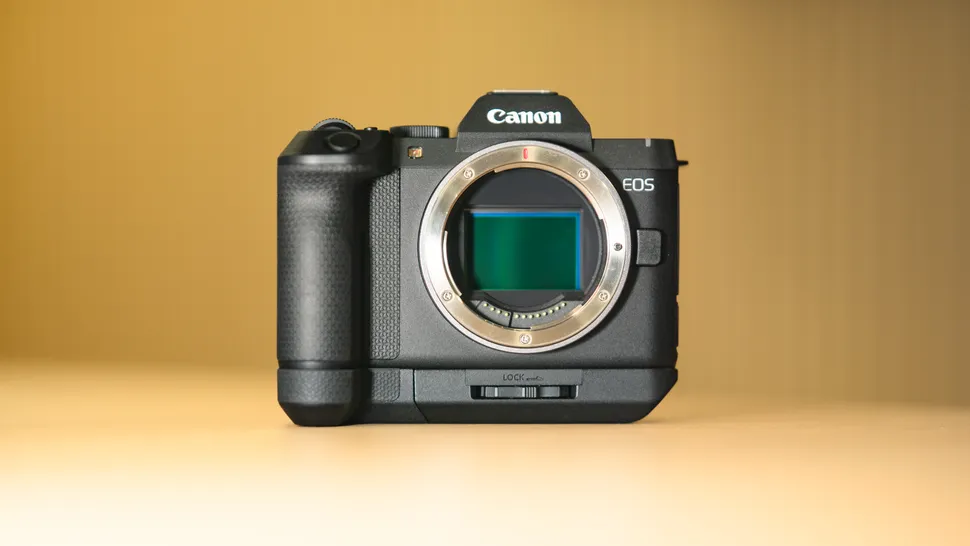 Canon EOS R8 Mark II được gắn báng cầm tay mở rộng trên mặt bàn gỗ