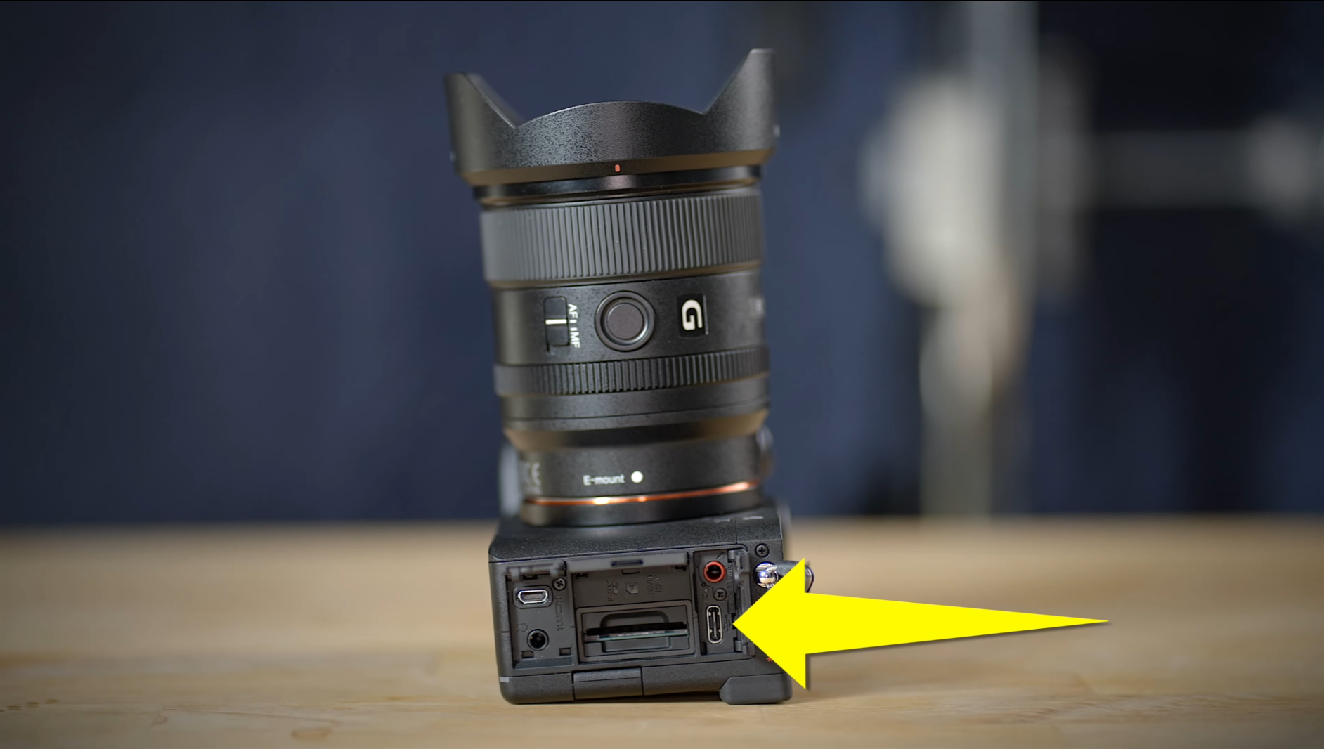 A camera with a yellow arrow pointing to it  Description automatically generated