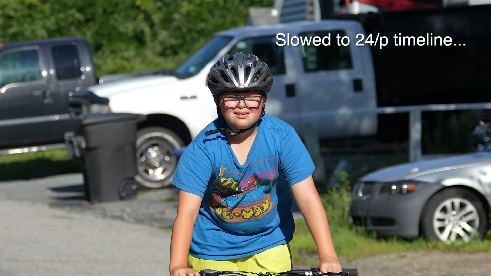 A child wearing a helmet and riding a bike  Description automatically generated