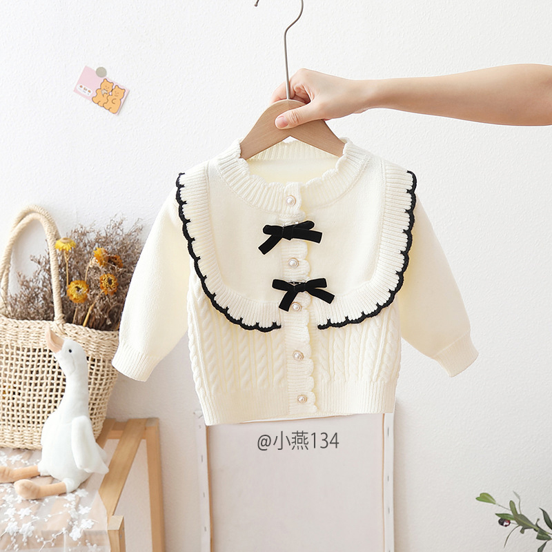 AK134-Cardigan len trắng nơ đen