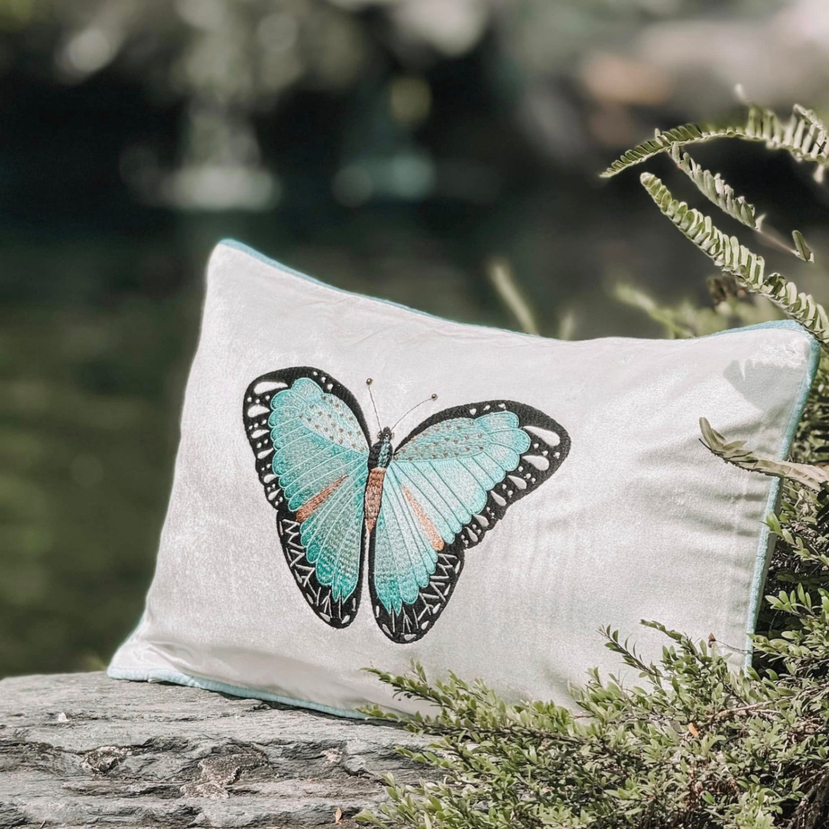 Beaded blue butterfly on ivory velvet cushion - Bướm xanh đính cườm trên nền gối nhung trắng ngà