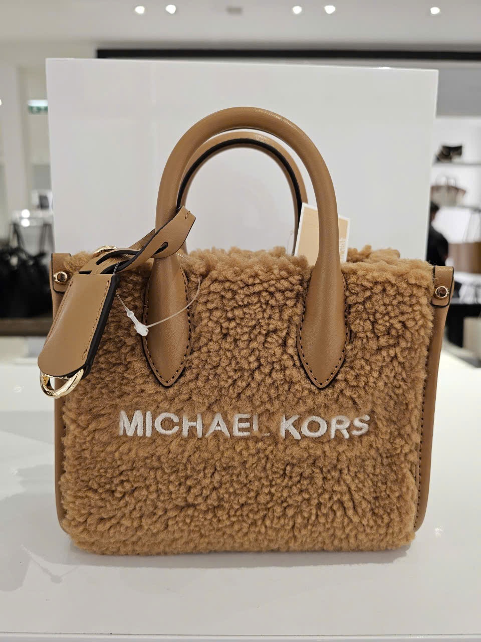 Túi MK nâu lông chữ trắng