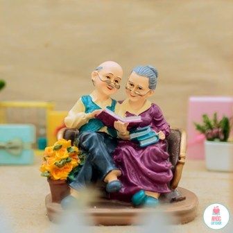 Tượng ông bà già ngồi đọc sách - 44001