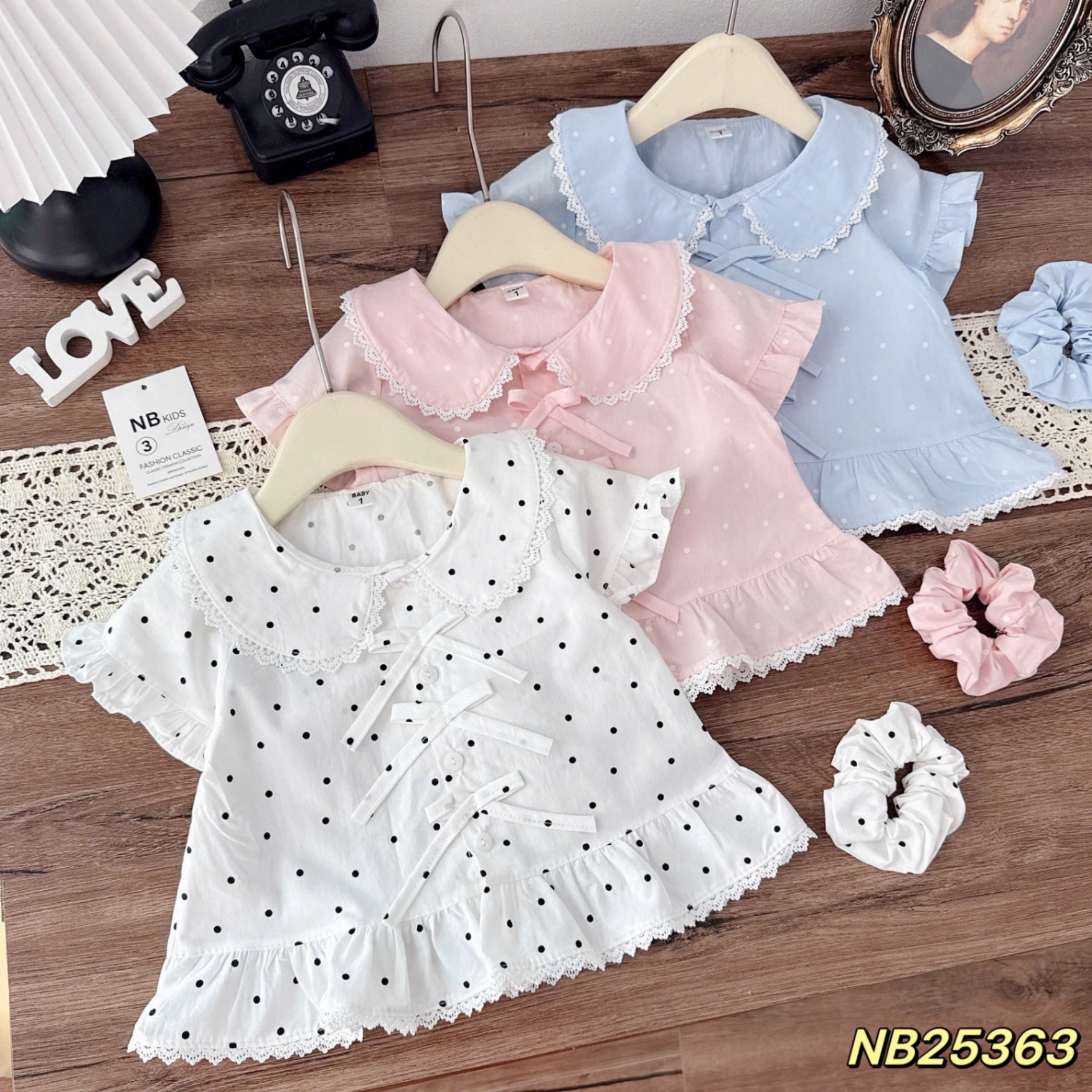 Áo sơ mi cổ sen đính nơ chấm bi bé gái