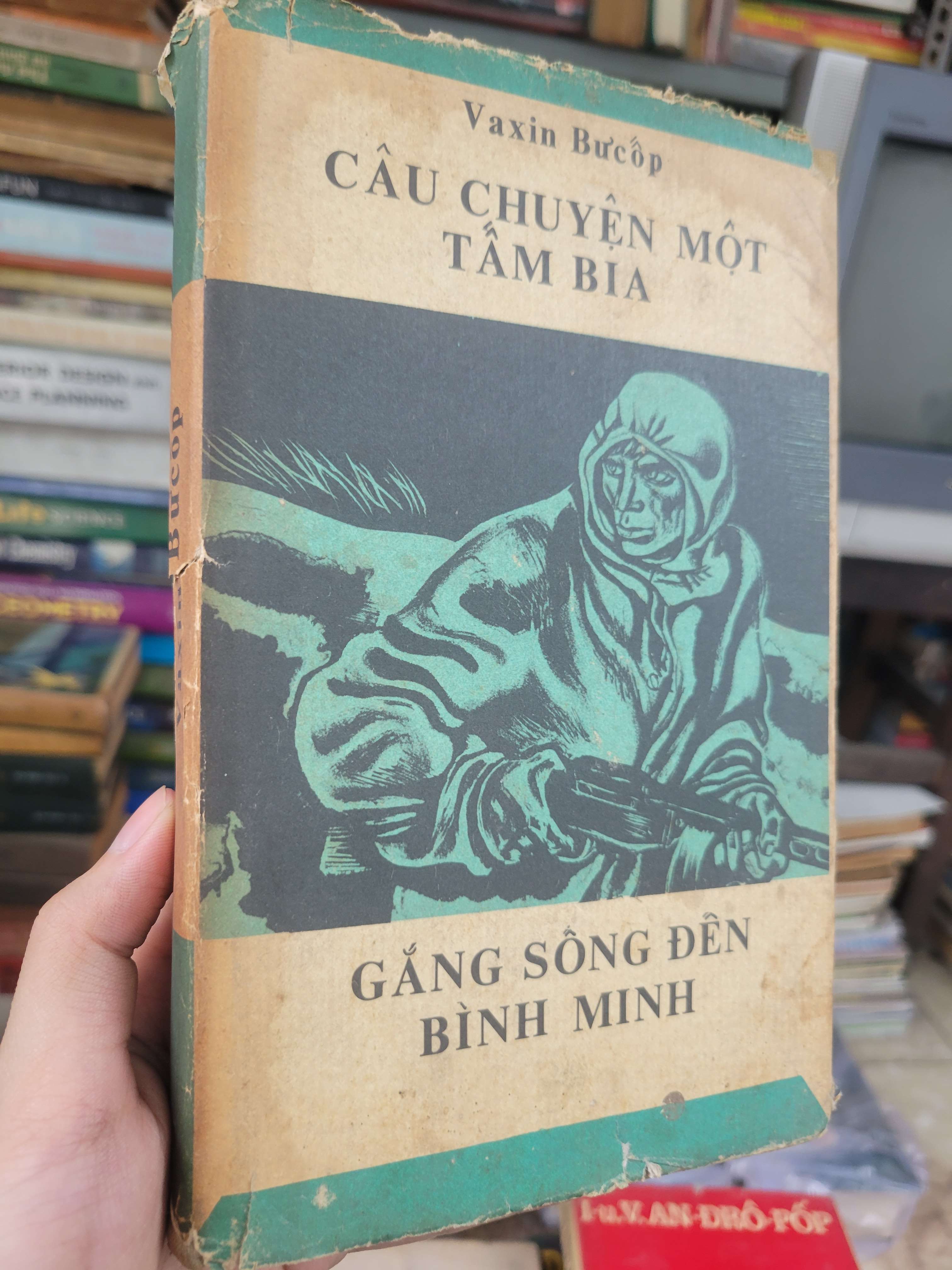 Câu chuyện một tấm bia: Gắng sống đến bình minh - Vaxin Bucop bìa cứng 1985 mới 70% bẩn bìa, ố, rách áo bìa (Sách văn học) BGB